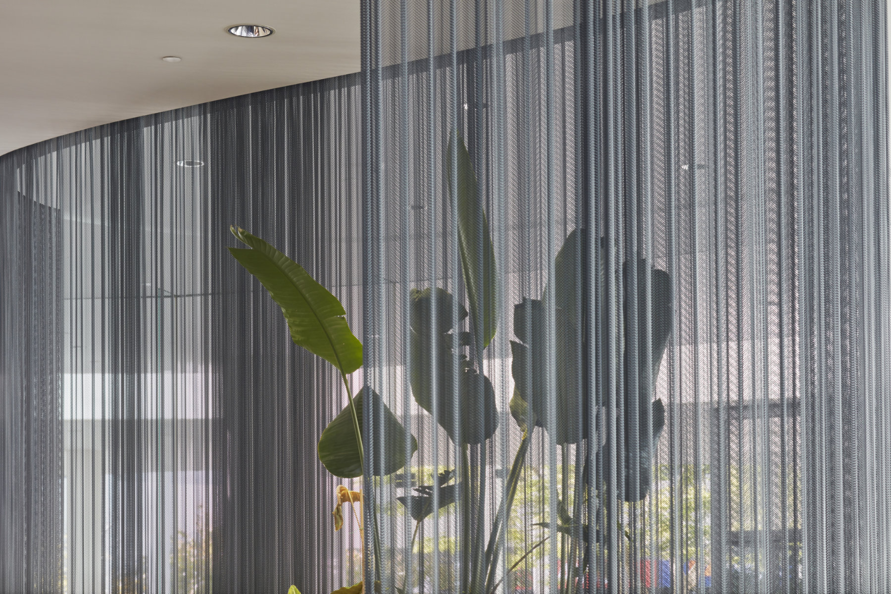 Fabricoil Interior Drapery, Metal Mesh Partition, Steel Coiled Wire Fabric in Gunmetal Black with Steel Secura Track Attachment System at QV1 Lobby, Australia - Plus Architecture